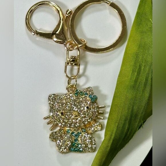 BAG CHARM Hello Kitty Gold Tone Blue Crystal Hair Bow Bag Charm Keychain - Picture 1 of 7